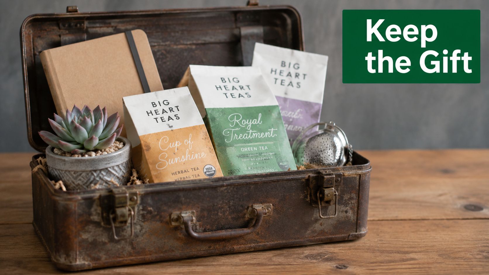 A rustic metal toolbox filled with tea bags, a small succulent plant, and a notebook on wood.